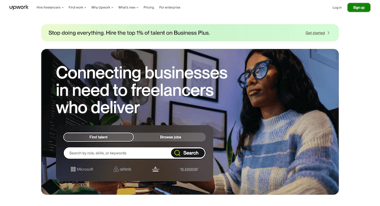 Woman using a computer in a dimly lit room; Upwork website interface offering options to find talent or browse jobs.