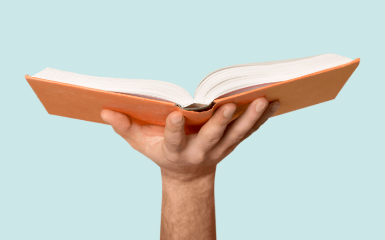Image of an open book in someone's hand